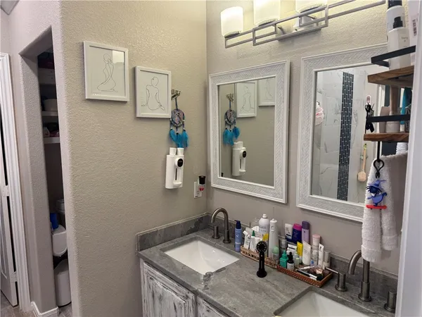 a bathroom with a sink vanity and mirror