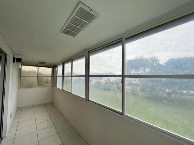 a view of a hallway with the entryway and wooden floor