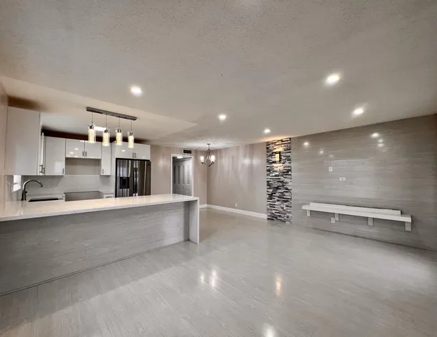 a view of kitchen with refrigerator and window