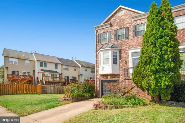 a view of a brick building next to a yard