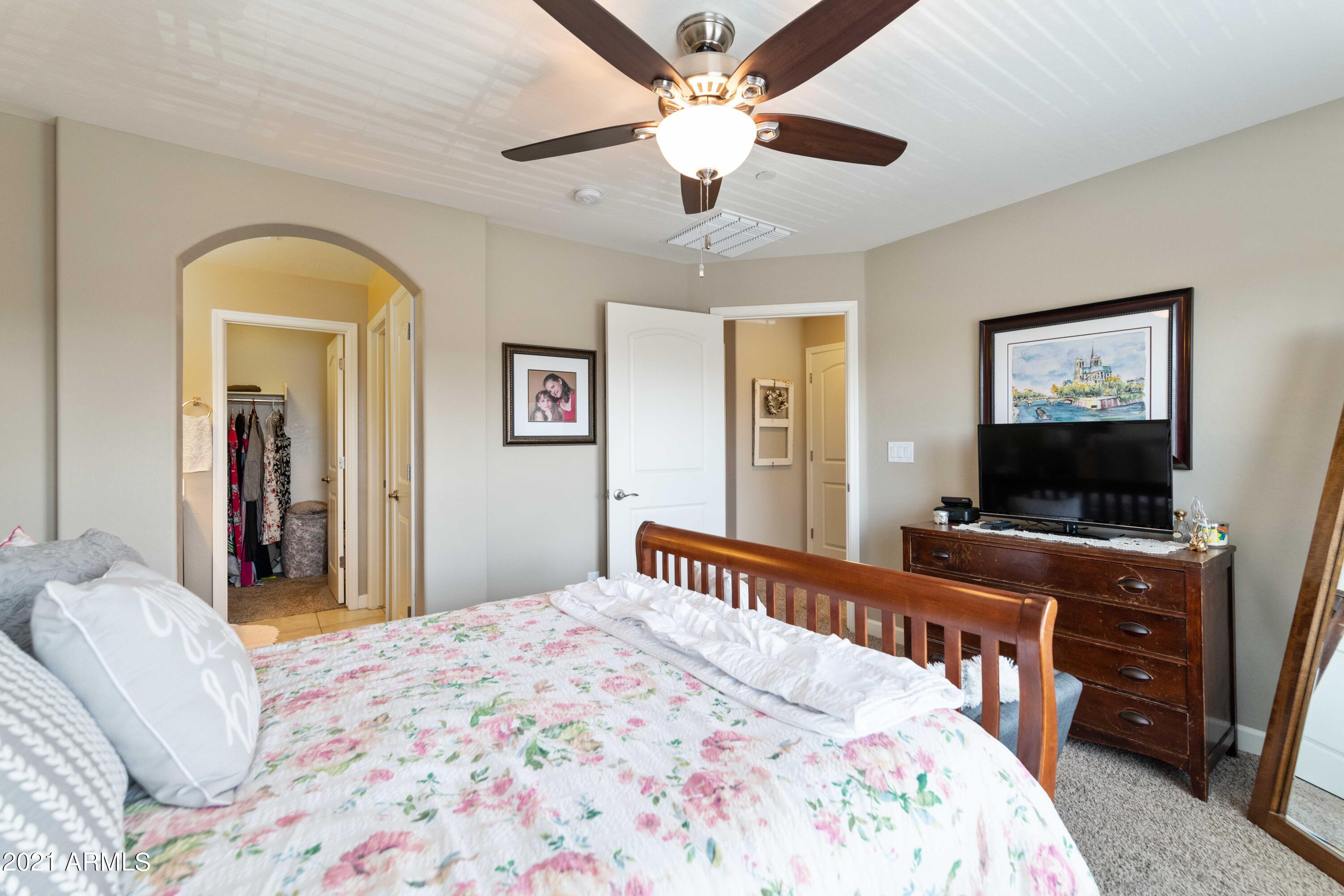 2150 West Alameda Road, Unit 1093 Phoenix, AZ 85085 - Photo 15 of 35 a bedroom with a bed and a flat screen tv