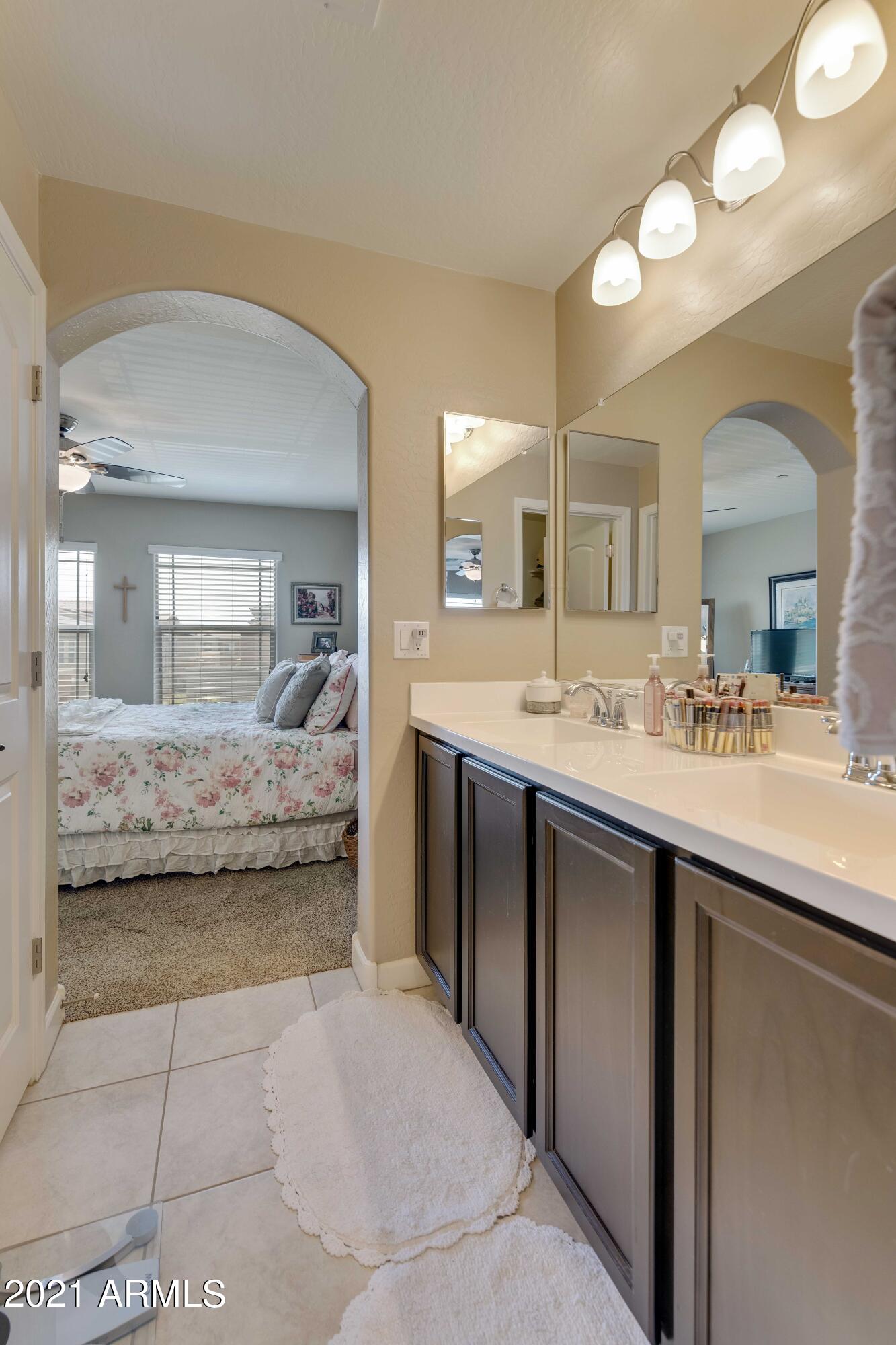 2150 West Alameda Road, Unit 1093 Phoenix, AZ 85085 - Photo 17 of 35 a en suite bathroom with a double vanity sink and a mirror