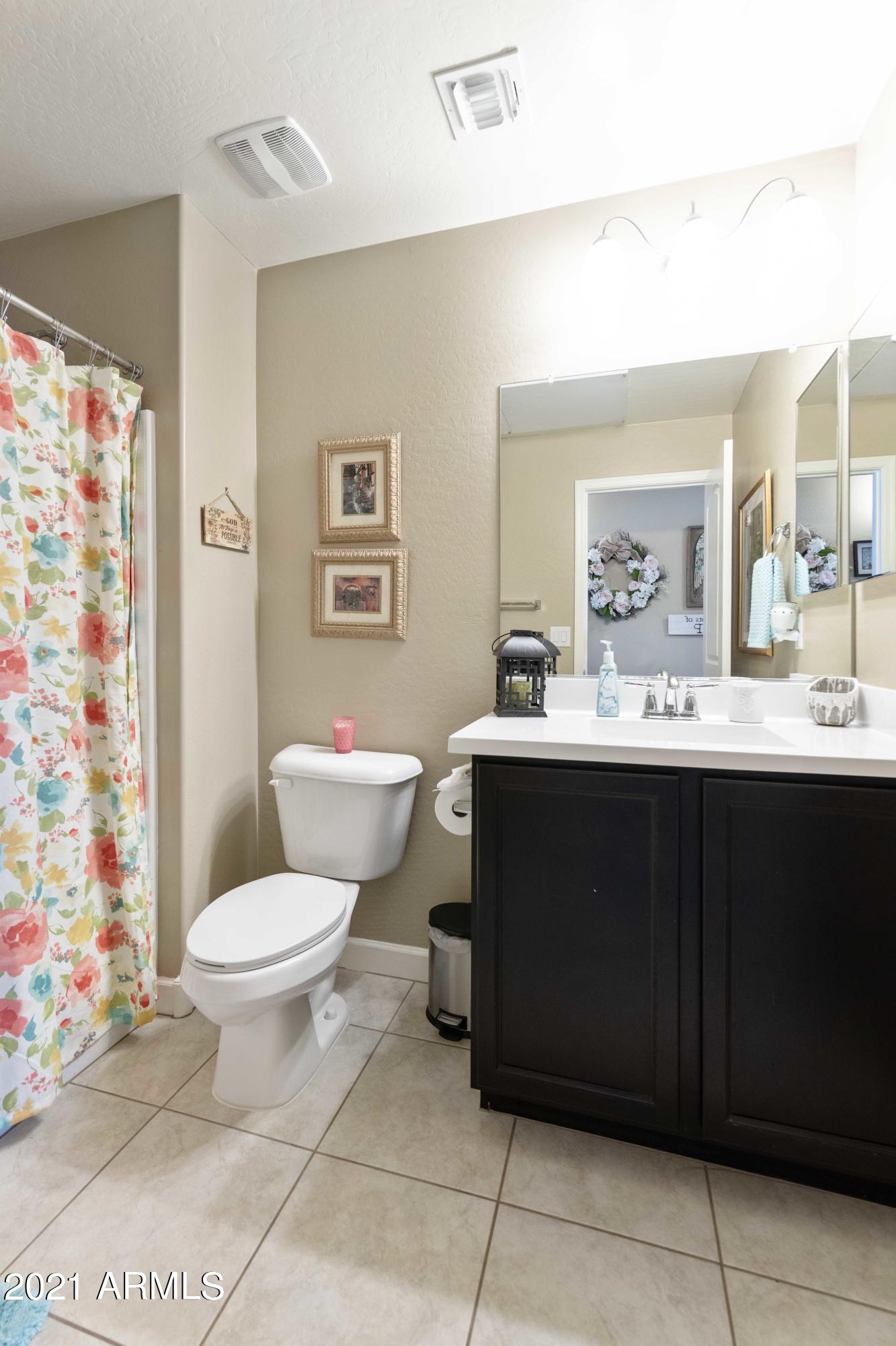2150 West Alameda Road, Unit 1093 Phoenix, AZ 85085 - Photo 21 of 35 a bathroom with a sink toilet and mirror