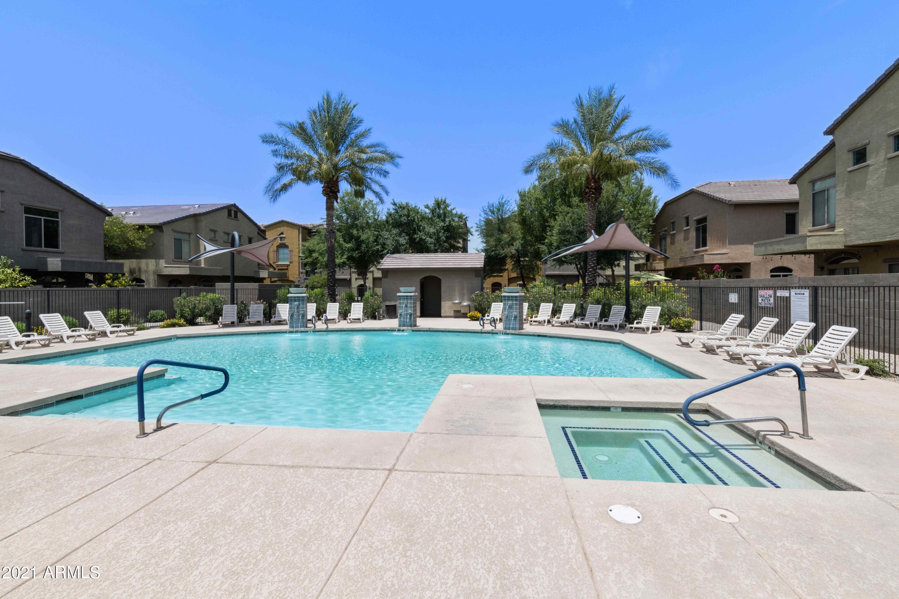 2150 West Alameda Road, Unit 1093 Phoenix, AZ 85085 - Photo 28 of 35 a view of a patio with table and chairs potted plants and a palm tree
