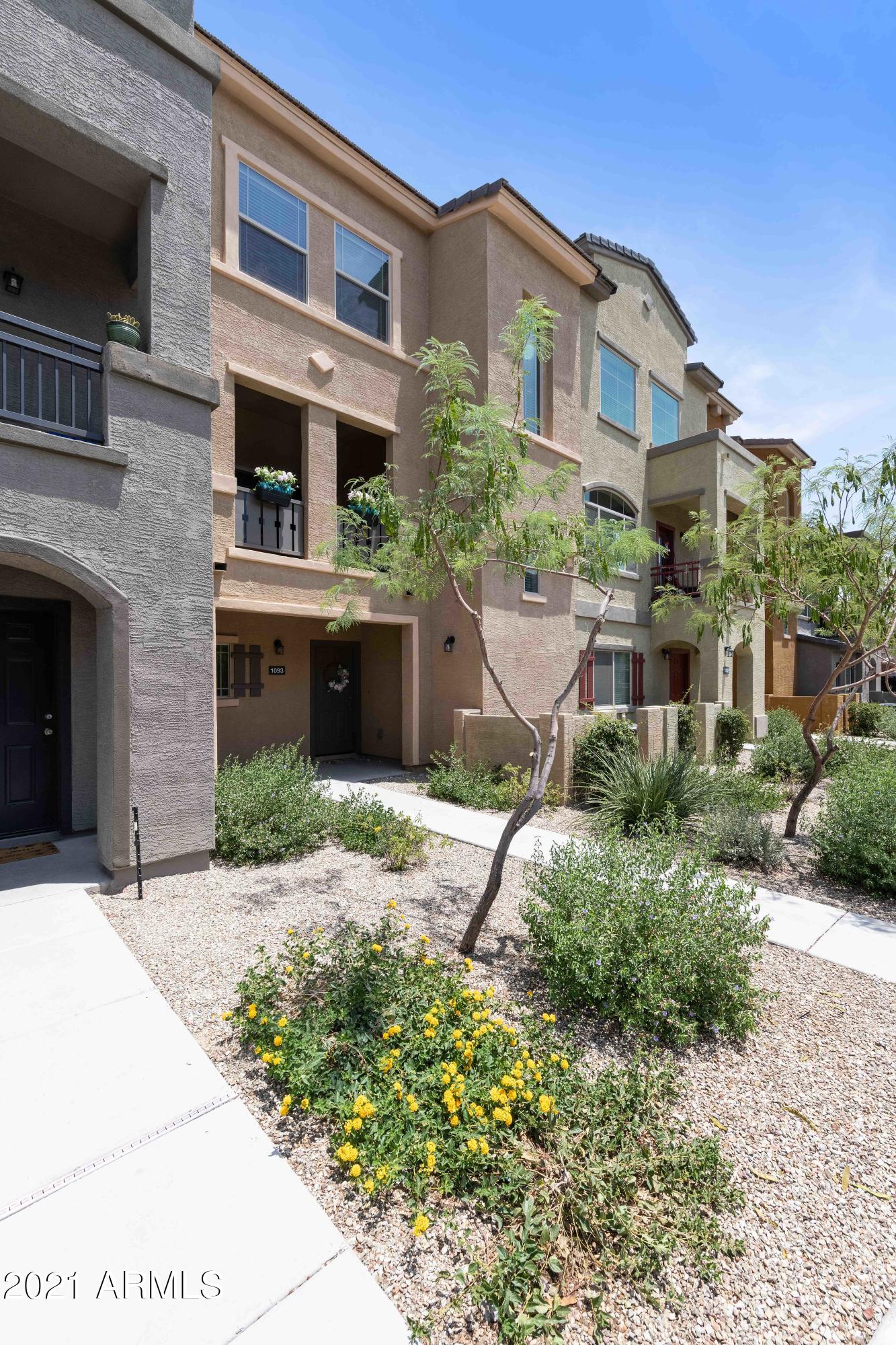 2150 West Alameda Road, Unit 1093 Phoenix, AZ 85085 - Photo 3 of 35 a front view of a house with a yard and potted plants