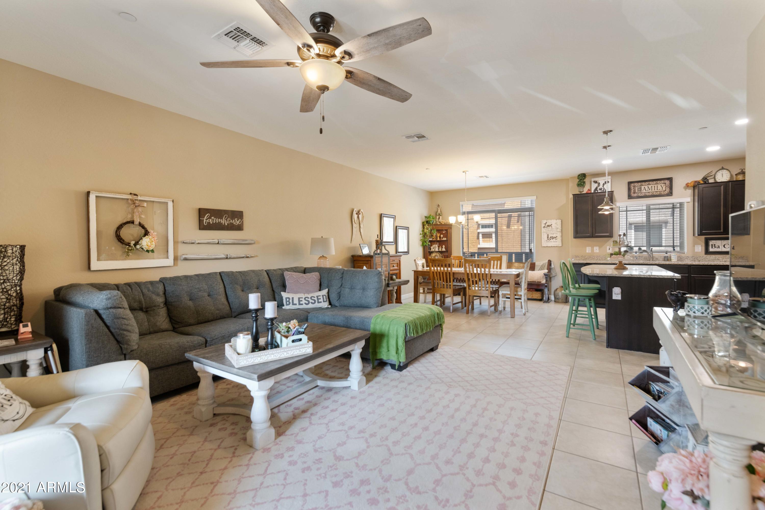 2150 West Alameda Road, Unit 1093 Phoenix, AZ 85085 - Photo 5 of 35 a living room with furniture kitchen view and a chandelier