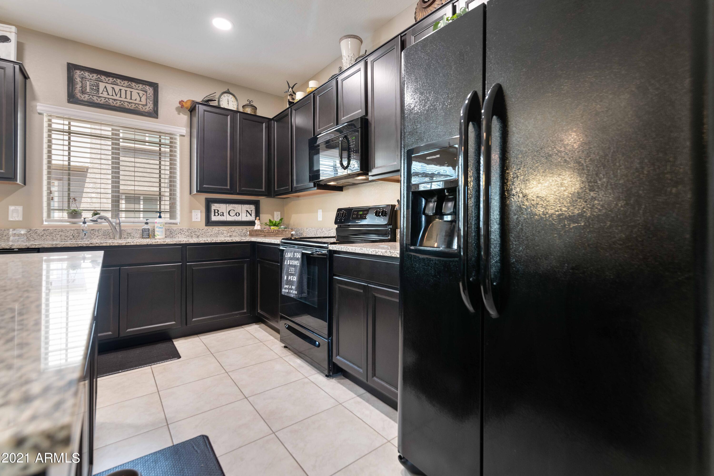 2150 West Alameda Road, Unit 1093 Phoenix, AZ 85085 - Photo 8 of 35 a kitchen with stainless steel appliances granite countertop a sink stove and refrigerator