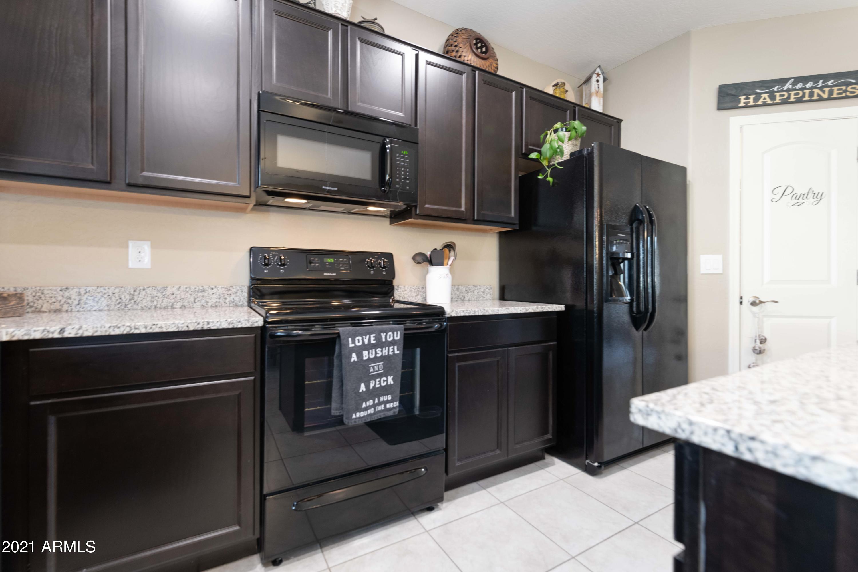 2150 West Alameda Road, Unit 1093 Phoenix, AZ 85085 - Photo 9 of 35 a kitchen with stainless steel appliances granite countertop a stove microwave and refrigerator