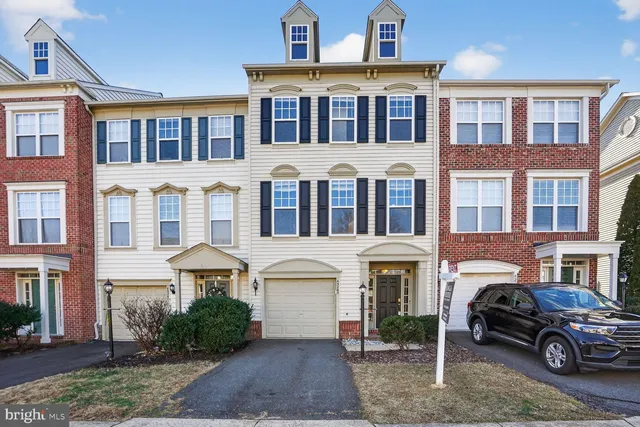 a front view of a residential apartment building with a yard