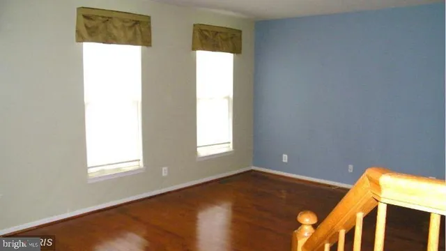 a large bed sitting in a bedroom next to a window
