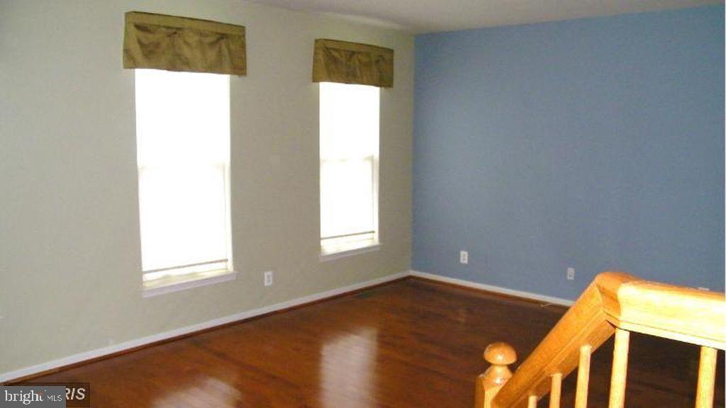 43265 Sunderleigh Square Broadlands, VA 20148 - Photo 23 of 27 a view of an empty room with wooden floor and a window