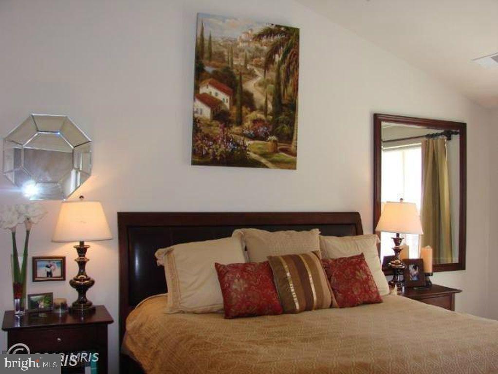 43265 Sunderleigh Square Broadlands, VA 20148 - Photo 24 of 27 a large bed sitting in a bedroom next to a window