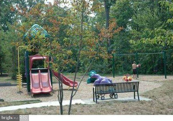 43265 Sunderleigh Square Broadlands, VA 20148 - Photo 25 of 27 a view of a wooden deck with a bench and wooden fence