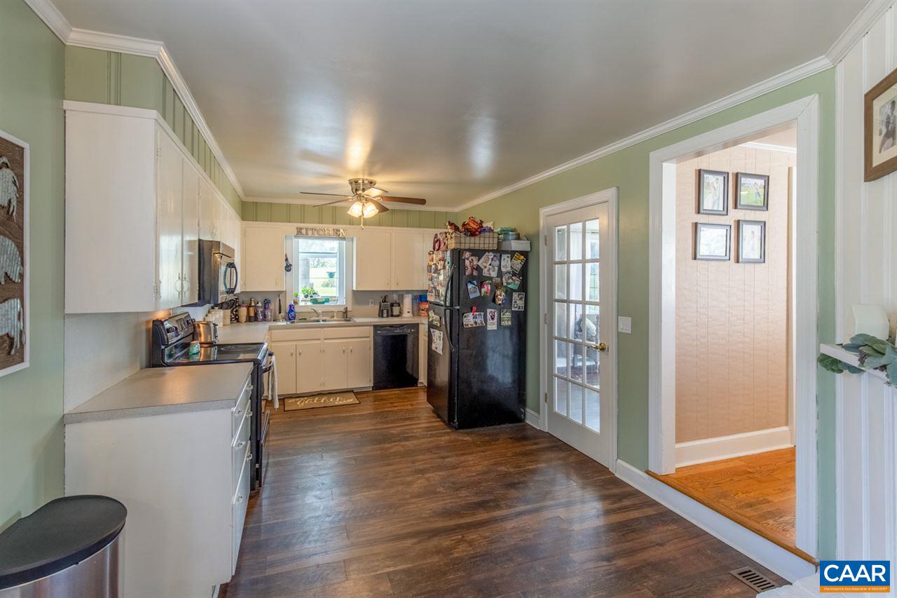 198 Keith Road Stanardsville, VA 22973 - Photo 28 of 49 a kitchen with stainless steel appliances kitchen island wooden floors and view living room