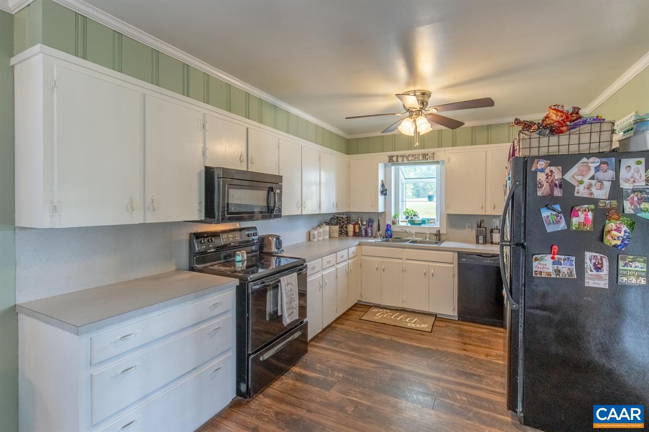 198 Keith Road Stanardsville, VA 22973 - Photo 29 of 49 a kitchen with stainless steel appliances granite countertop a stove cabinets and wooden floor