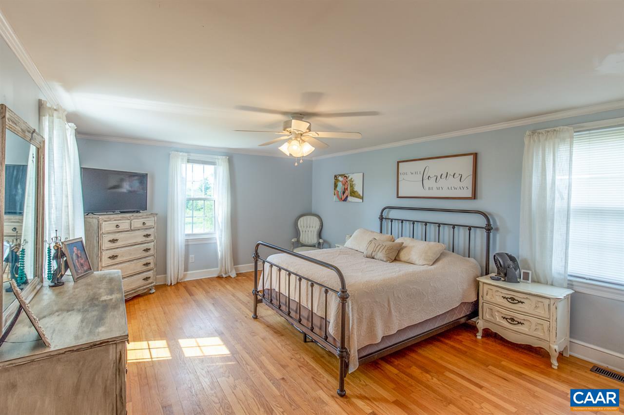 198 Keith Road Stanardsville, VA 22973 - Photo 40 of 49 a bedroom with a bed and a chandelier