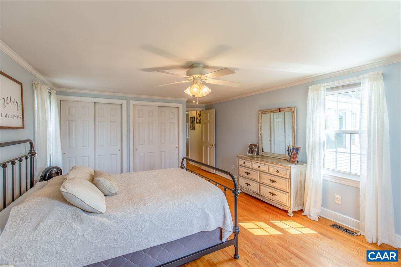 198 Keith Road Stanardsville, VA 22973 - Photo 41 of 49 a bedroom with a bed and a chandelier