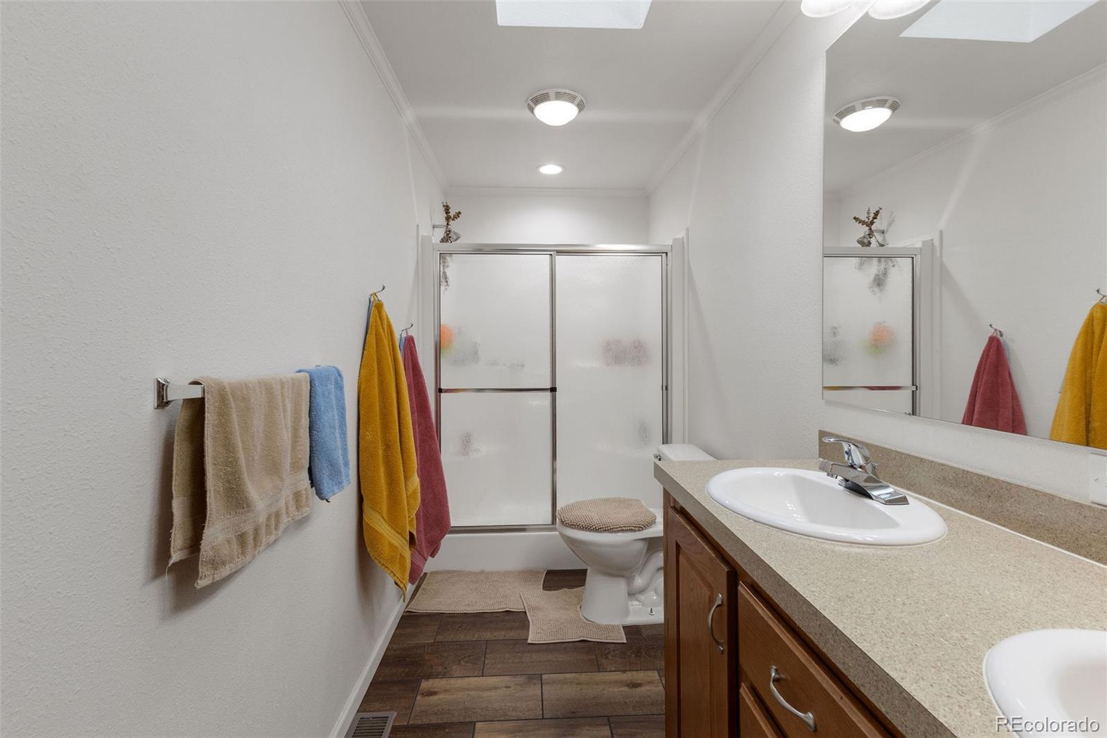 574 4th Street Bennett, CO 80102 - Photo 13 of 21 a bathroom with a sink toilet and a shower