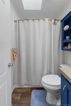 a bathroom with a toilet and a shower curtain