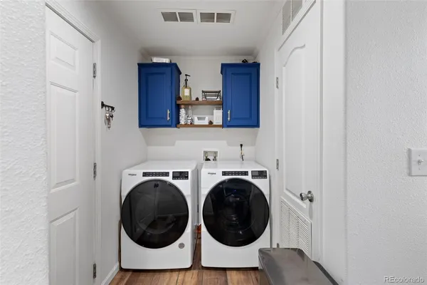 a utility room with sink dryer and washer