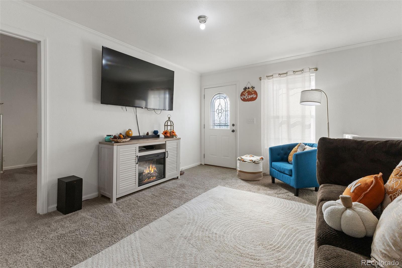 574 4th Street Bennett, CO 80102 - Photo 4 of 21 a living room with furniture and a flat screen tv