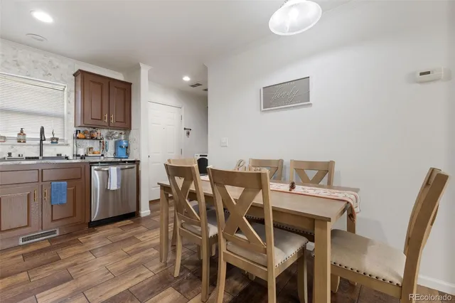 a view of a dining room with furniture and wooden floor