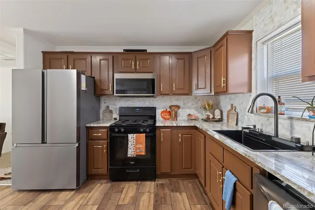a kitchen with a sink appliances and cabinets