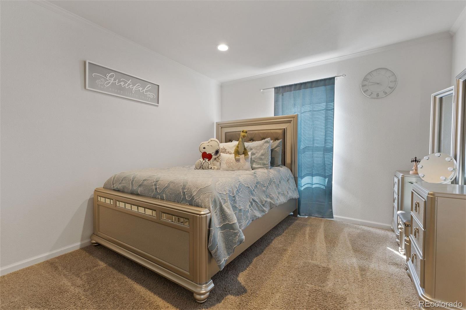 574 4th Street Bennett, CO 80102 - Photo 9 of 21 a room with a bed and a flat screen tv