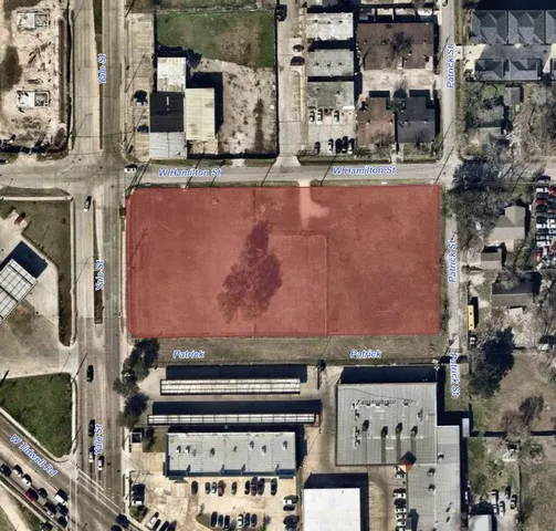 an aerial view of a residential apartment building with a yard