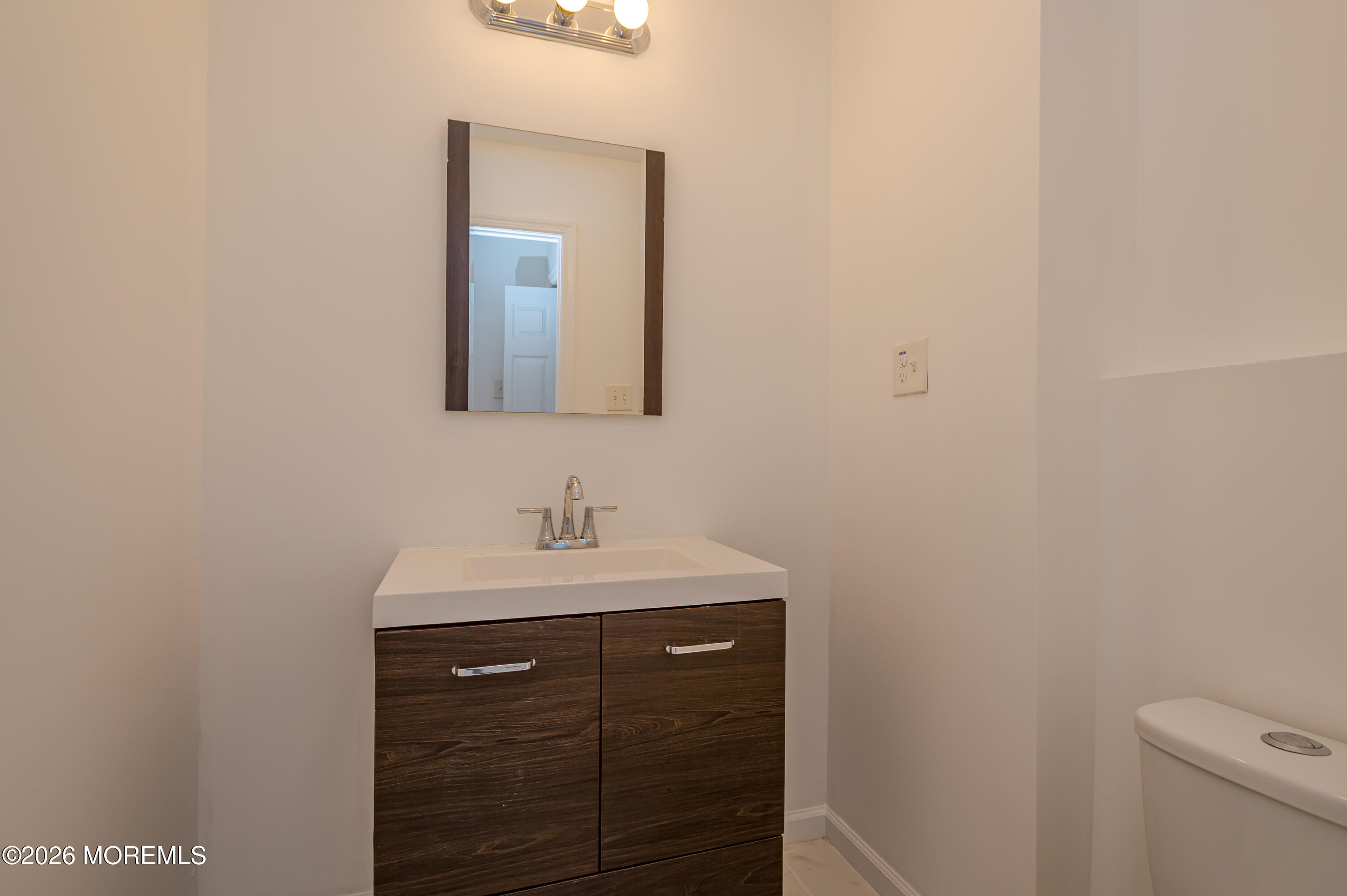 608 Alpine Trail Neptune Township, NJ 07753 - Photo 3 of 27 a bathroom with a sink a toilet and mirror