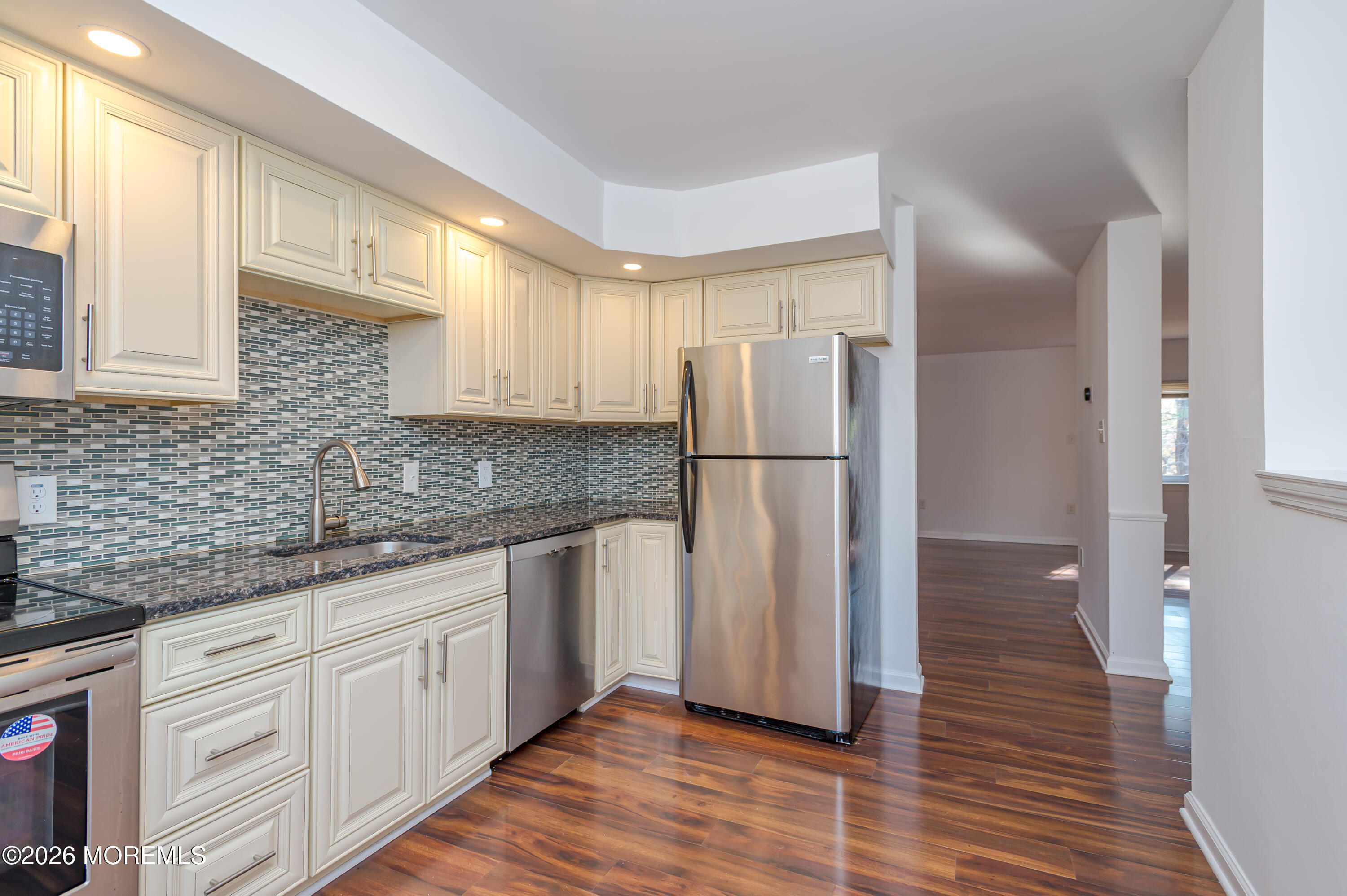 608 Alpine Trail Neptune Township, NJ 07753 - Photo 4 of 27 a kitchen with a refrigerator and a sink