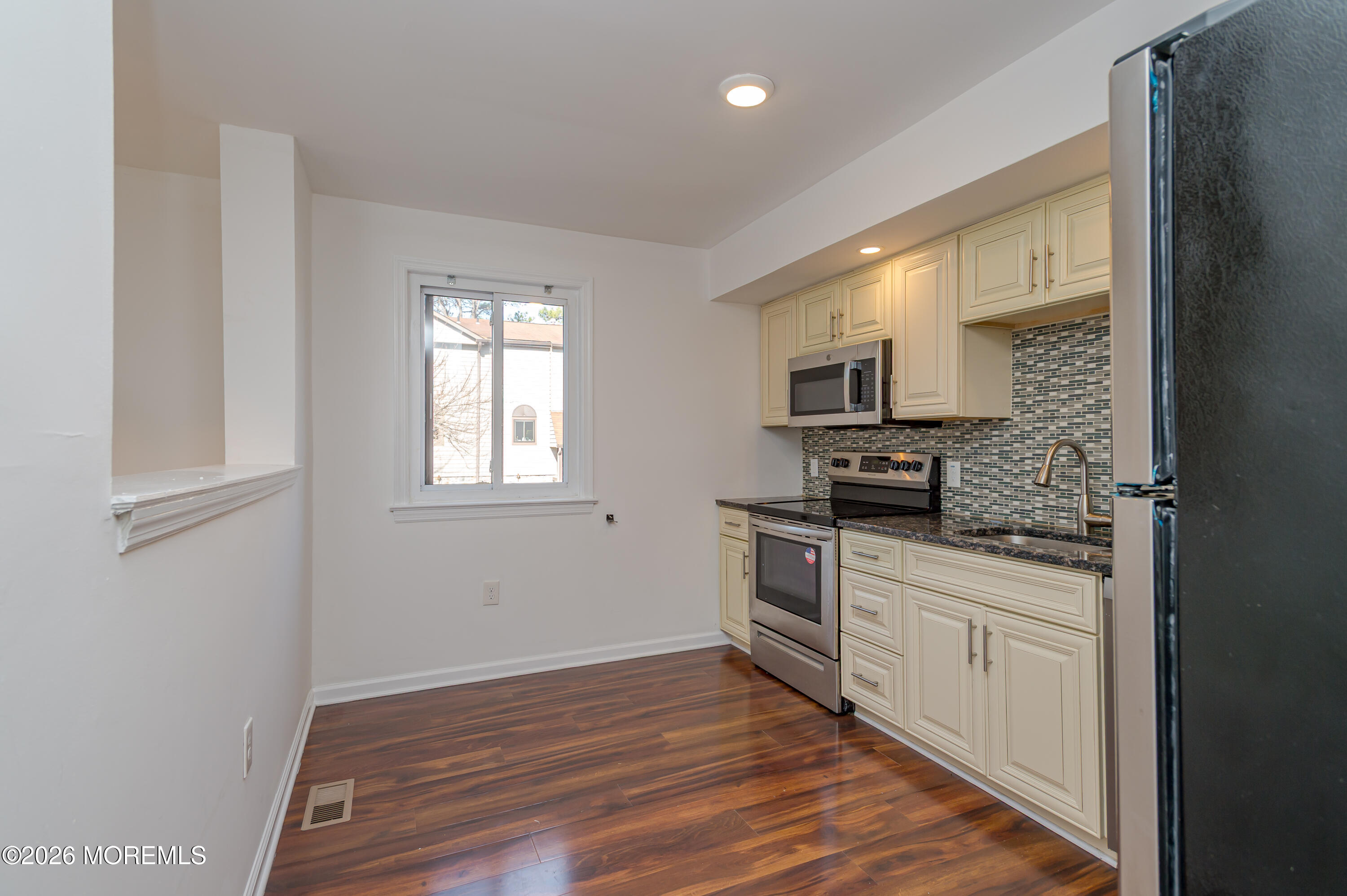 608 Alpine Trail Neptune Township, NJ 07753 - Photo 5 of 27 a kitchen with stainless steel appliances granite countertop a stove a sink and a microwave