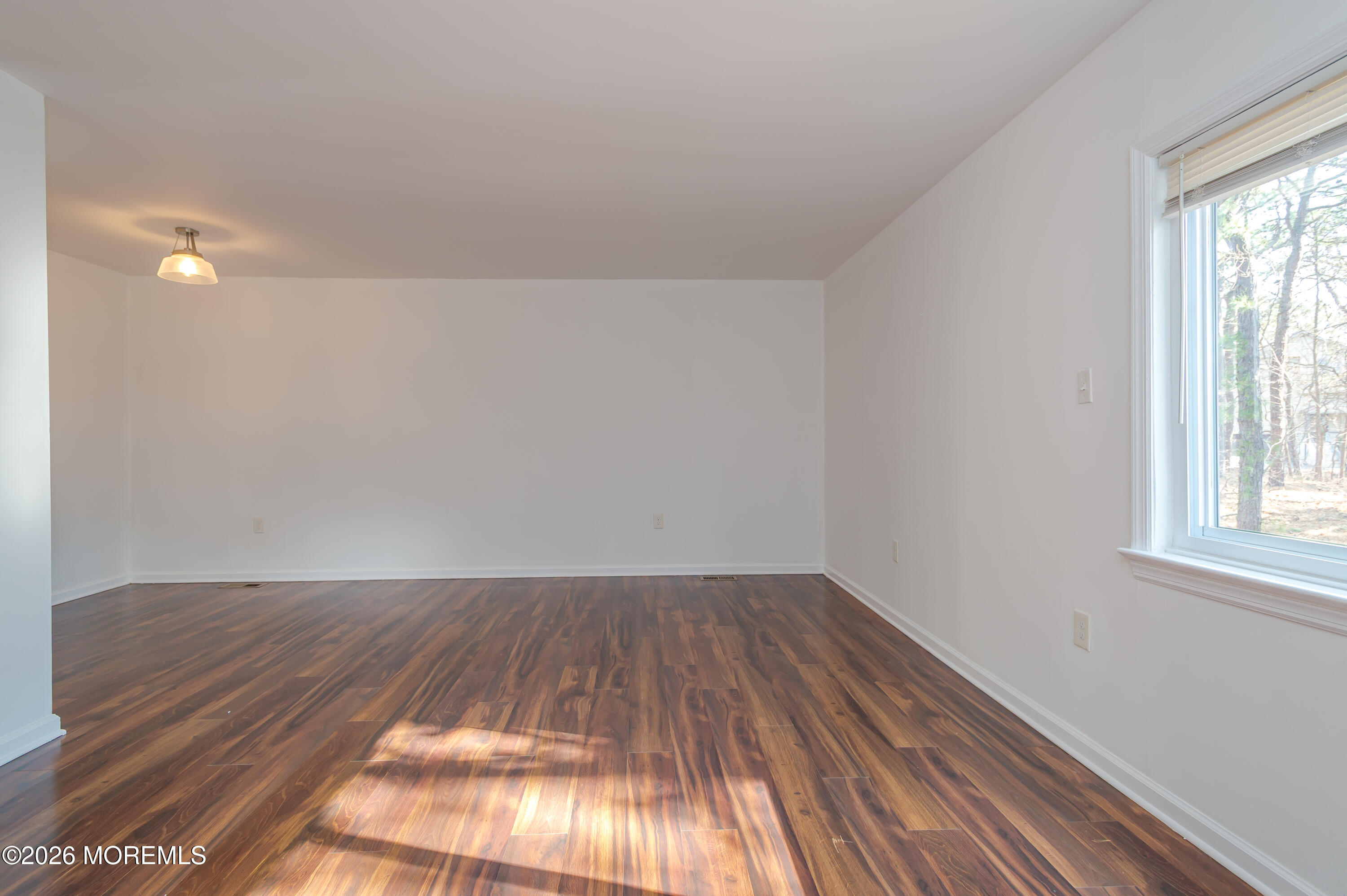 608 Alpine Trail Neptune Township, NJ 07753 - Photo 10 of 27 an empty room with wooden floor and windows