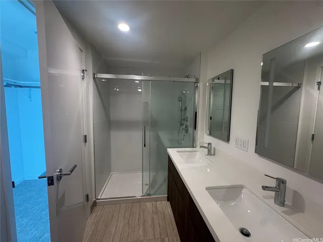 a bathroom with a shower sink and mirror