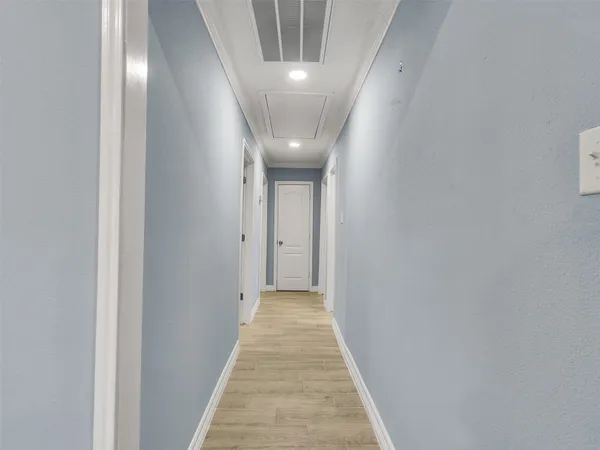 a view of a hallway with wooden floor