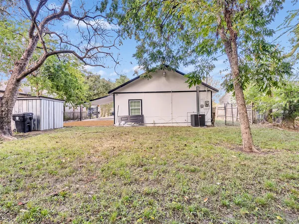 a tree in front of a white house