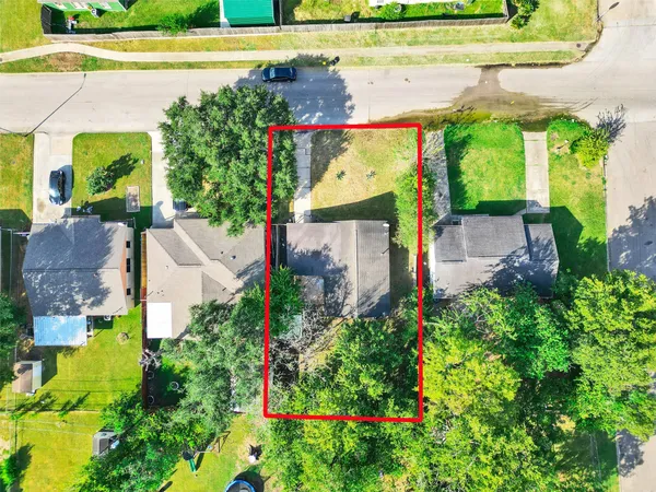 an aerial view of a house with a garden and swimming pool