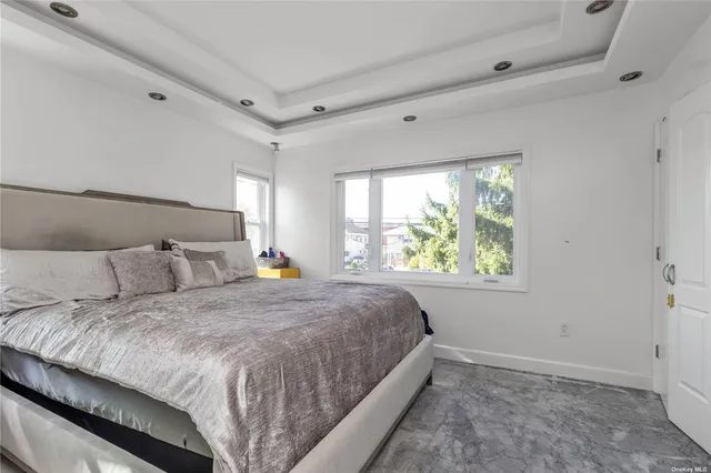 a bed sitting in a bedroom next to a window