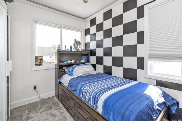 a bedroom with a bed and a window