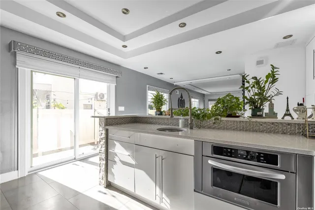 a kitchen with a stove and a potted plant