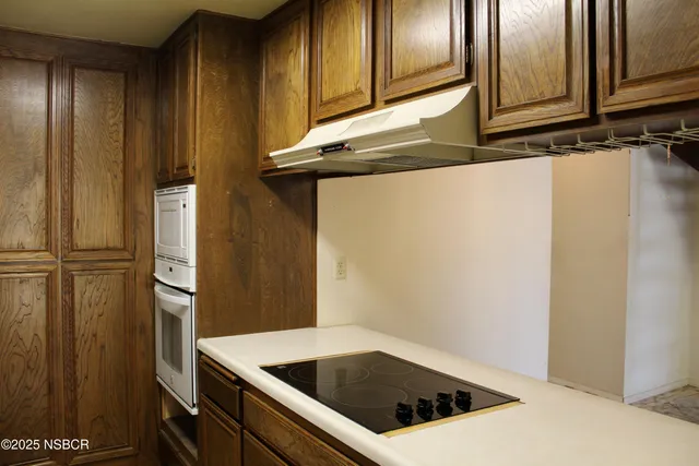 a kitchen with a refrigerator and cabinets