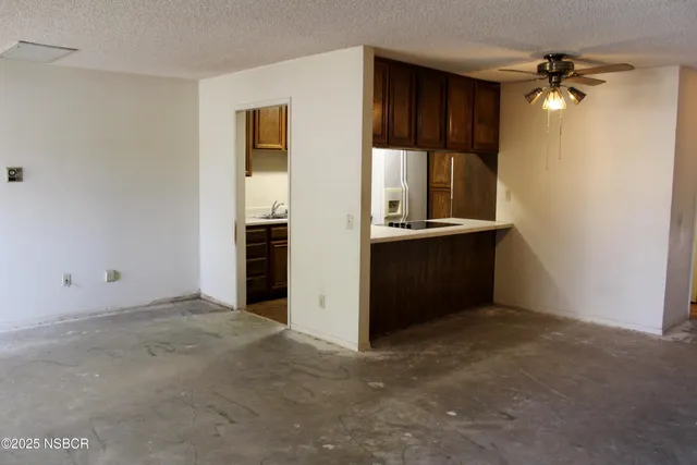 an empty room with closet and windows