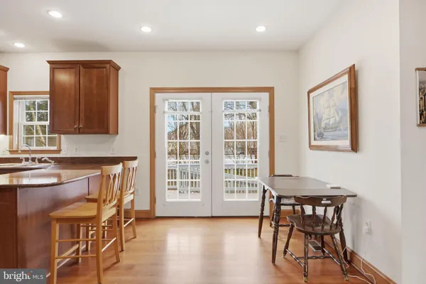 a view of a a dining room with furniture window and wooden floor