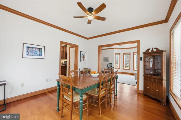 a dining room with furniture and wooden floor