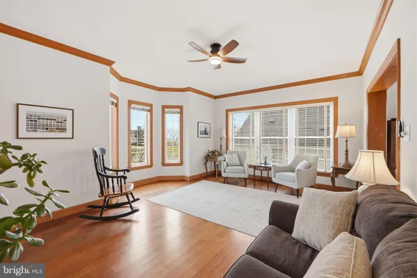 a living room with furniture flat screen tv and a large window