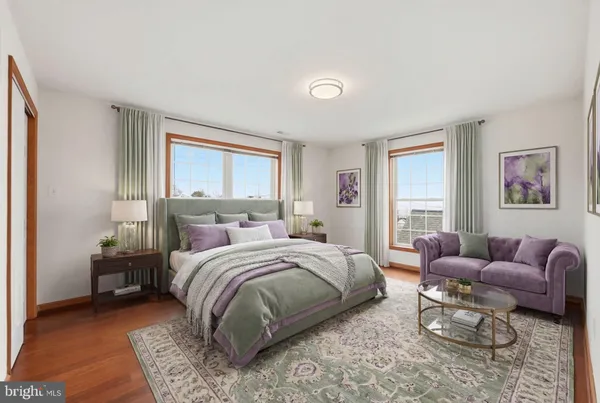 a bedroom with a bed couch and a window