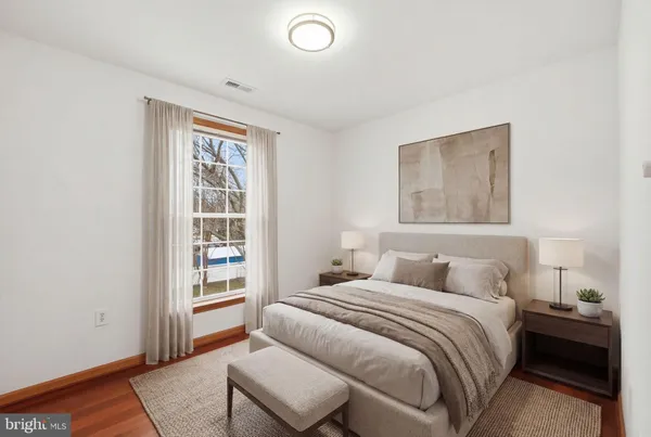 a bedroom with bed and a window