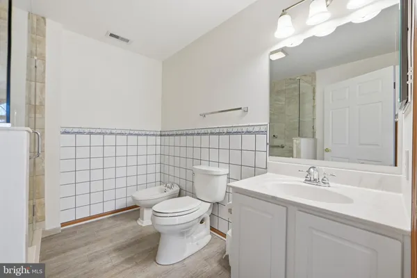 a bathroom with a toilet sink and shower