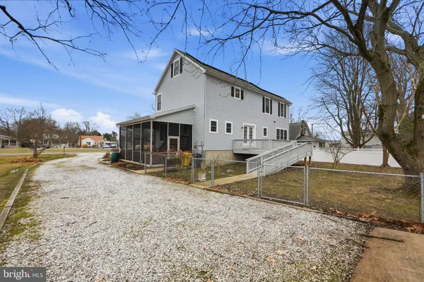 a view of a house with a yard covered in snow