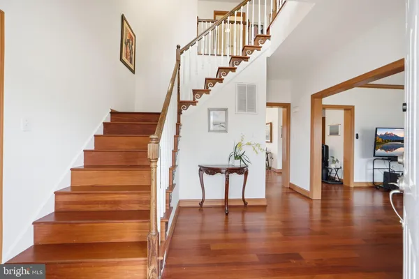 a living room with furniture a flat screen tv and a large window